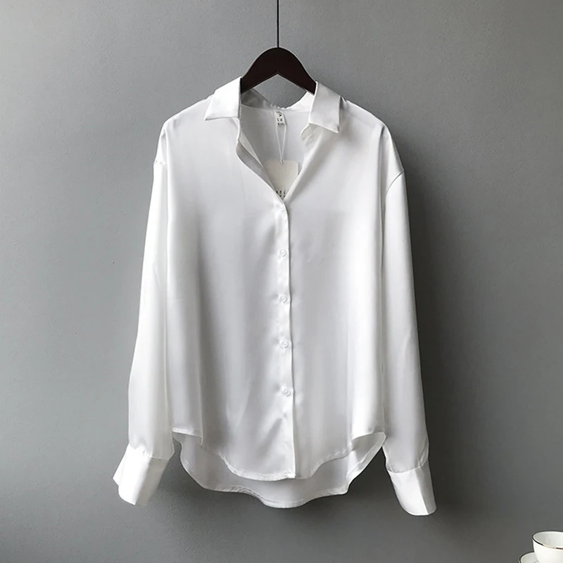 Elegant white satin blouse with a turn-down collar, full sleeves, and vintage charm for versatile styling.