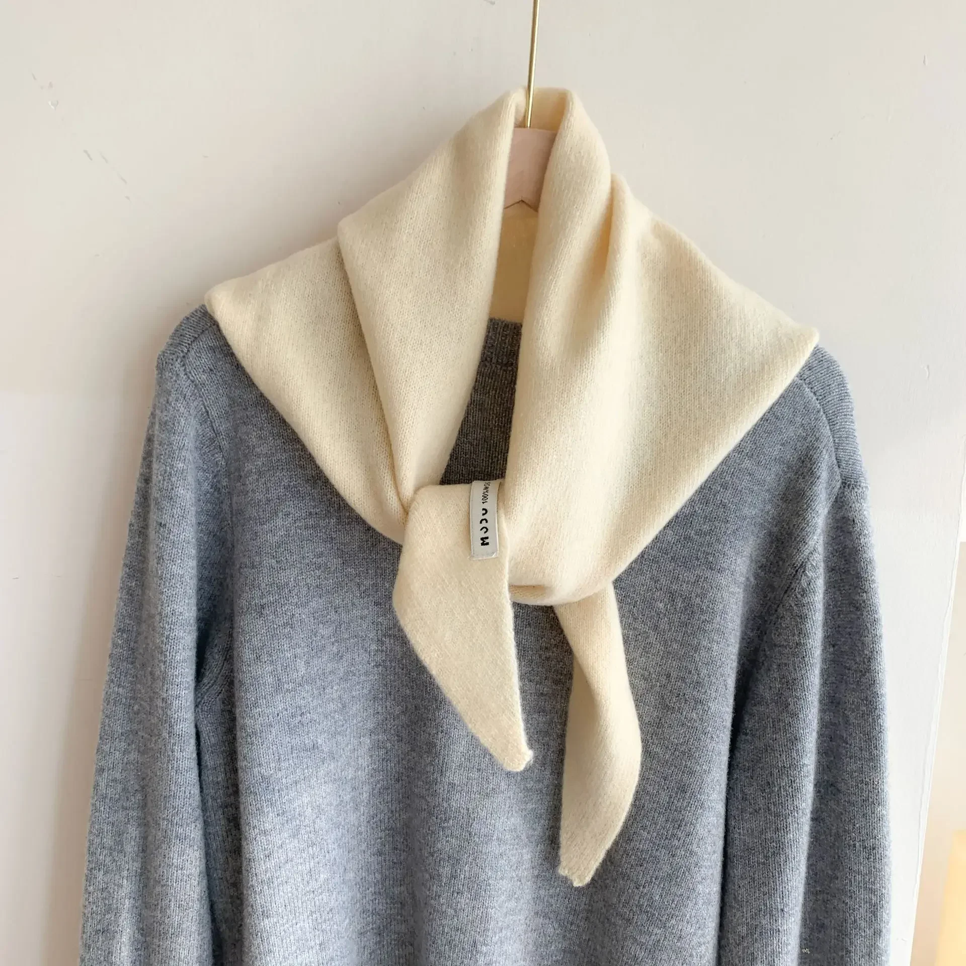 Luxurious cashmere-wool scarf with a unique triangular design, perfect for versatile, stylish wear.